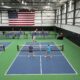 "Pickleball players enjoying a match on TPS Court Surfacing at Topseed Pickleball in Tulsa."