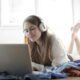 woman in white shirt using silver macbook.