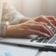 person typing on keyboard