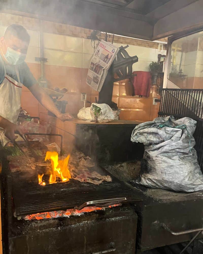 man cooking carne asada in oaxaca