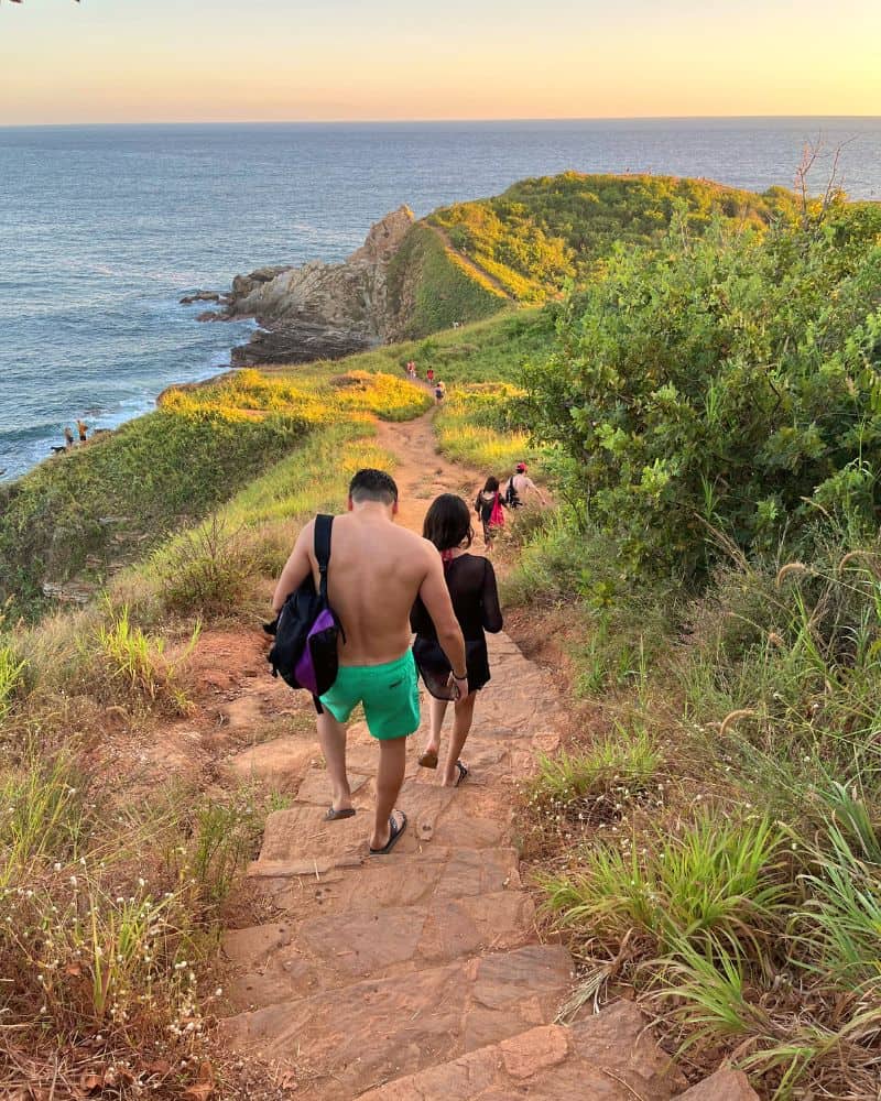 people walking on the pathway to punta cometa mazunte hike