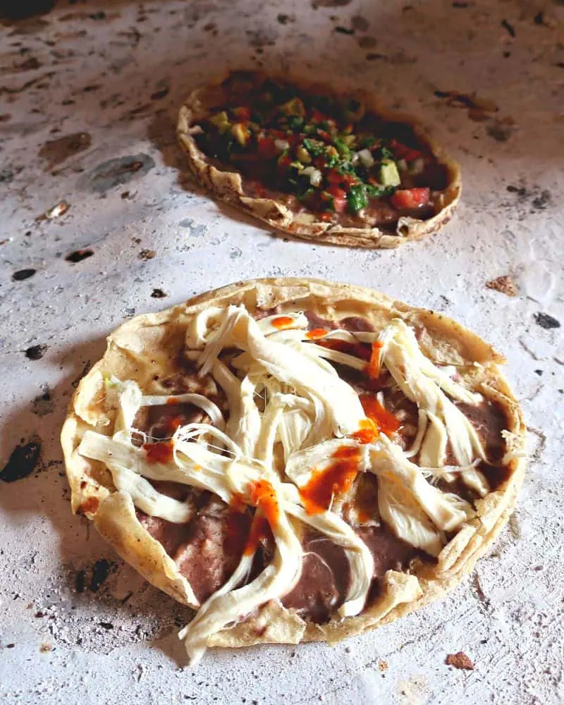 oaxaca memelas cooking on a comal