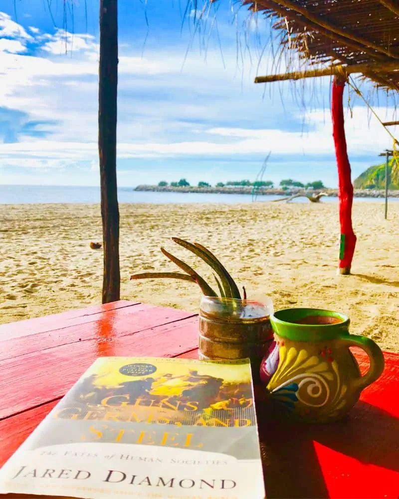 book on the table at a beach cafe