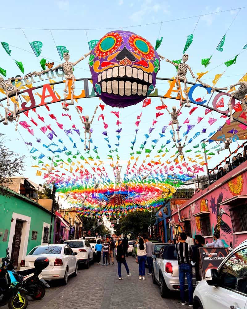 colorful flags hung above the street in jalatlaco oaxaca city mexico