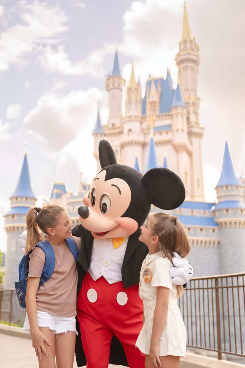 Enchanting Disney castle with Mickey Mouse mascot for family vacation fun.