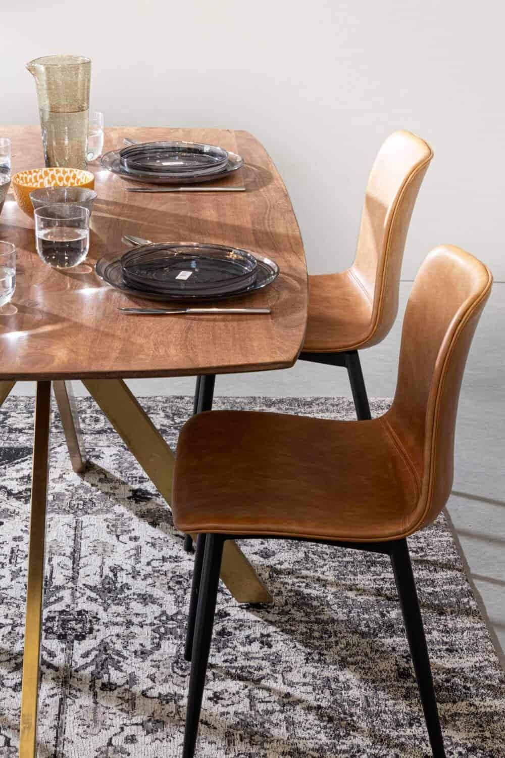 Sedie in pelle marrone e tavolo in legno per cucina moderna e elegante.