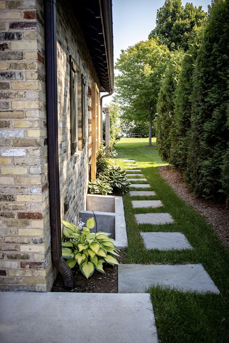 side of home with stone path