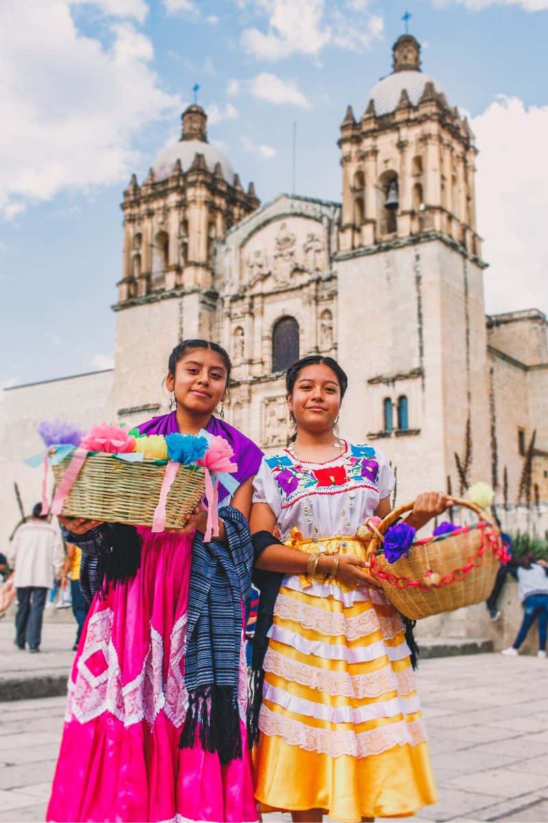 two women in traditional dress in oaxaca city, mexico