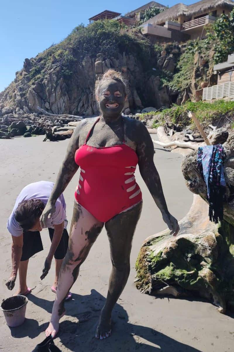 woman getting mud massage in huatulco at playa la bocana beach