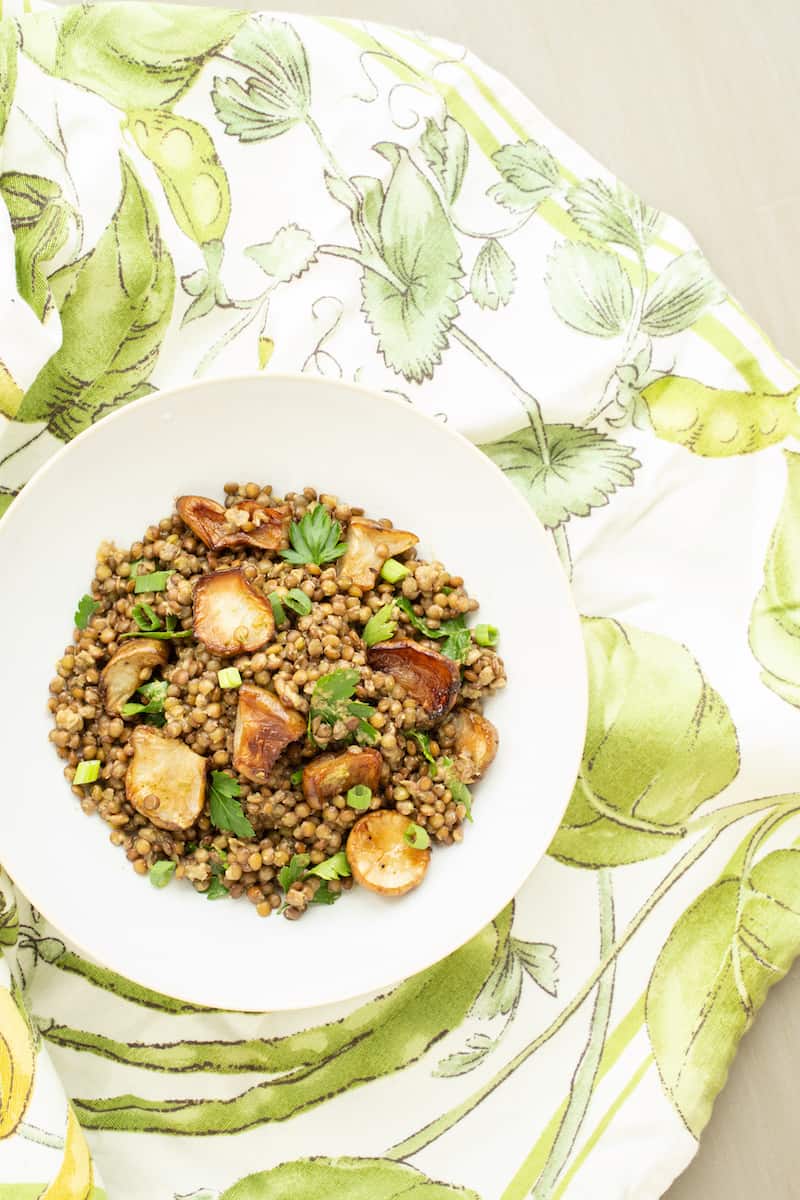 A warm lentil salad mixes French lentils with roasted Jerusalem artichokes, or sunchokes, in a cozy and comforting vegetarian winter dish.