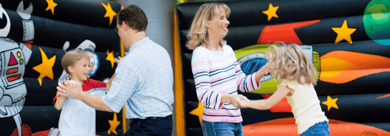 Family jumping together inside an inflatable bounce house rental in Central Kentucky