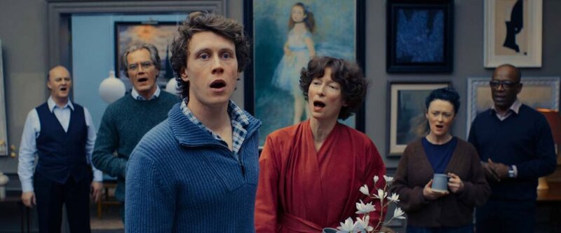 A group of characters singing together in a room filled with eclectic paintings, representing the ritualised family life in The End.
