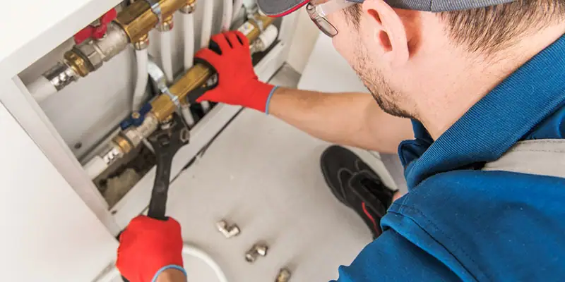 homemade water filtration - Hire Professional Plumbers - plumber adjusting pipes with a wrench