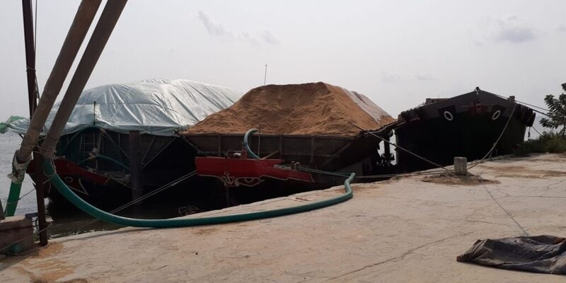 A boat in Vietnam full of rice husks, potentially used for biochar production.
