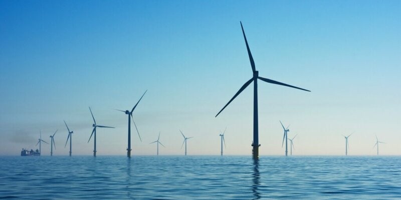 A long row of windmills in the ocean