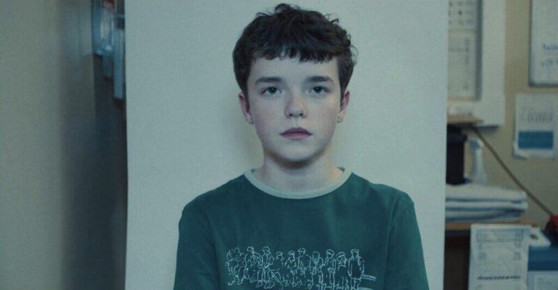 Portrait-style frame from Adolescence focusing on the young protagonist staring directly at the camera, symbolizing innocence and inner turmoil.