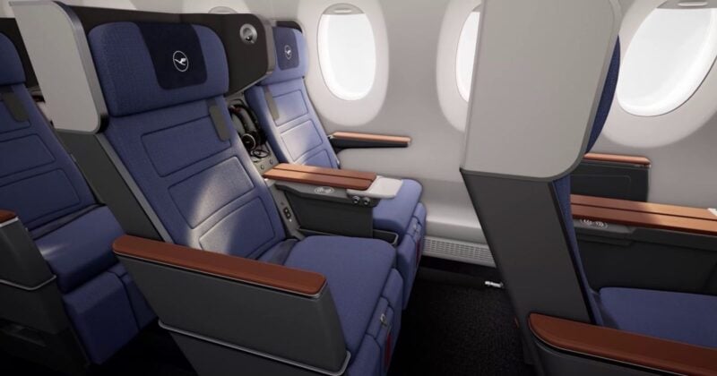 Lufthansa Allegris Premium Economy cabin seats with blue upholstery and privacy shell design.