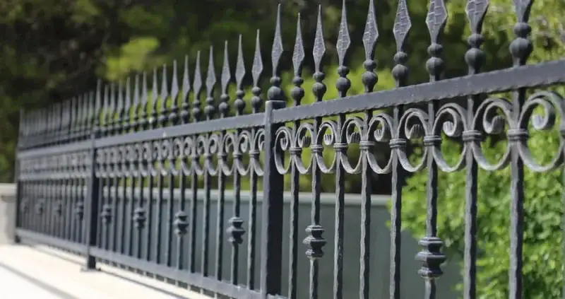 Decorative black metal fence and gate custom-fabricated by Weldit in Houston, Texas.