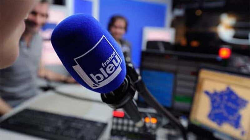 Radio studio with microphone and broadcasting equipment at Quantilia.