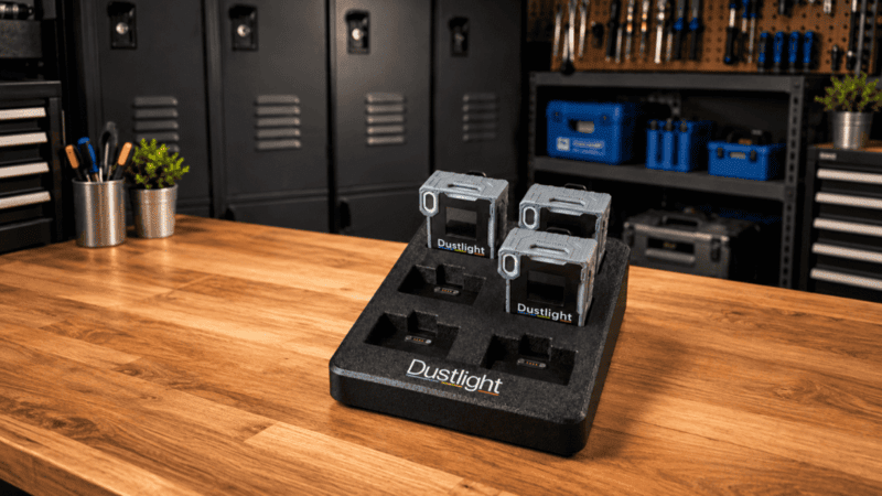 Dustlight Charging and Data Dock with Three Devices on a Workbench