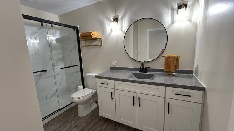 Cottage bathroom with walk-in shower and vanity at Romaine Valley Weddings & Events in Fenton, Missouri