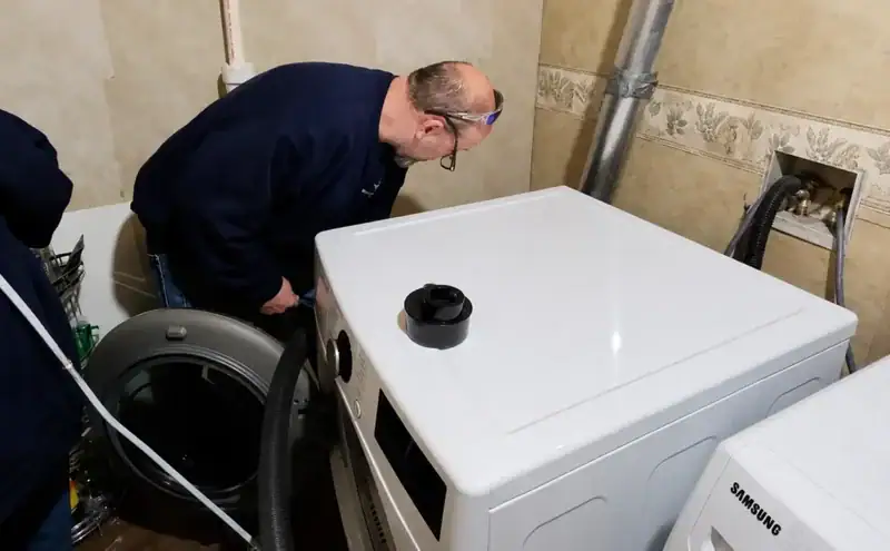 Professional technician cleaning a residential dryer vent in Missouri