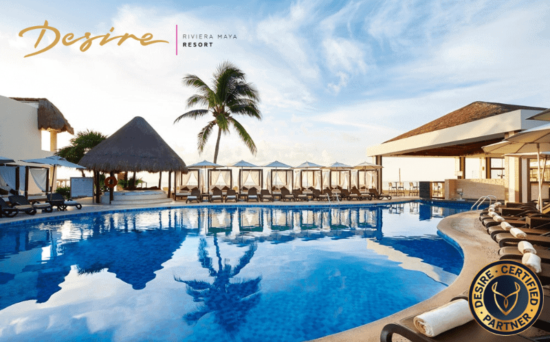 Swimming pool area at Desire Riviera Maya Resort with lounge chairs and cabanas.