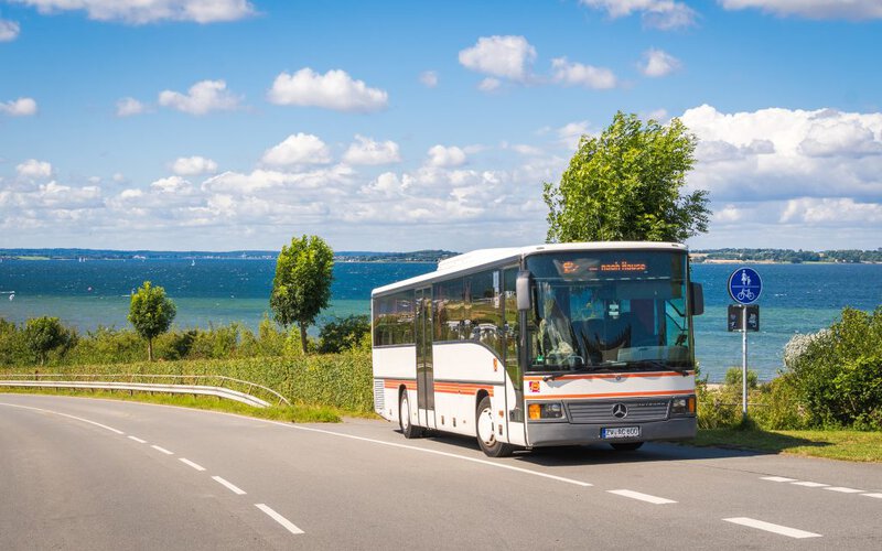Ehemaliger Bus der Ambos GmbH vor Kulisse der Flensburger Förde.