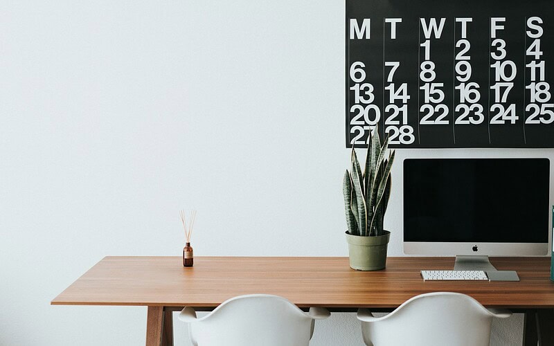 silver iMac on brown wooden desk