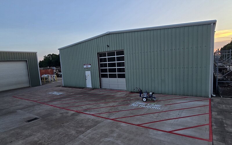 Red fire lane striping with NO PARKING stencils in Houston