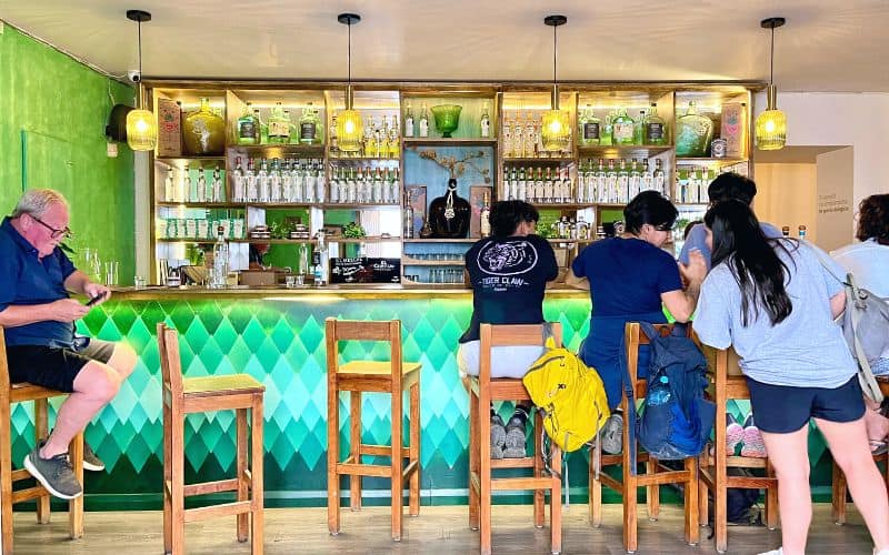 people sitting at a bar in oaxaca called El Cortijo Mezcaleria