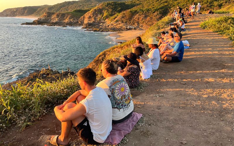 people watching the sunset at punta cometa oaxaca