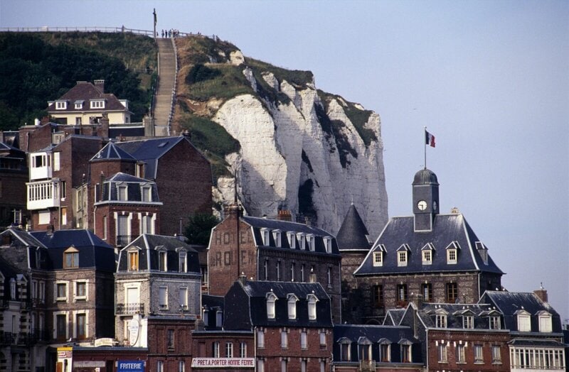 Historische Stadt mit roten Backsteinhäusern und Kalksteinklippen in Nordfrankreich.