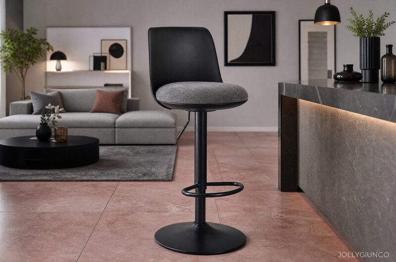 Black bar stool with gray cushion at a marble kitchen island in a modern living room setup.