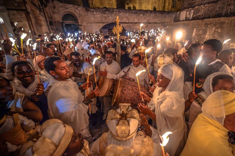 Pilgrims gathered at dawn in Lalibela for Genna – Ethiopian Orthodox Christmas celebration with chanting, candles, and traditional white garments