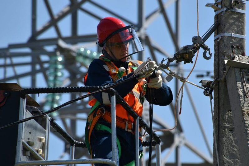 Electrical technician working on a power line