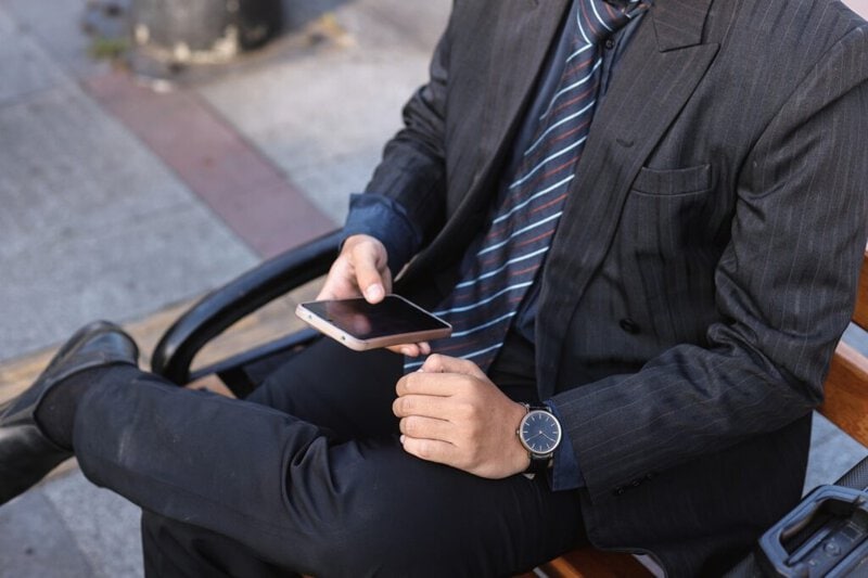 businessman in suit checking social media