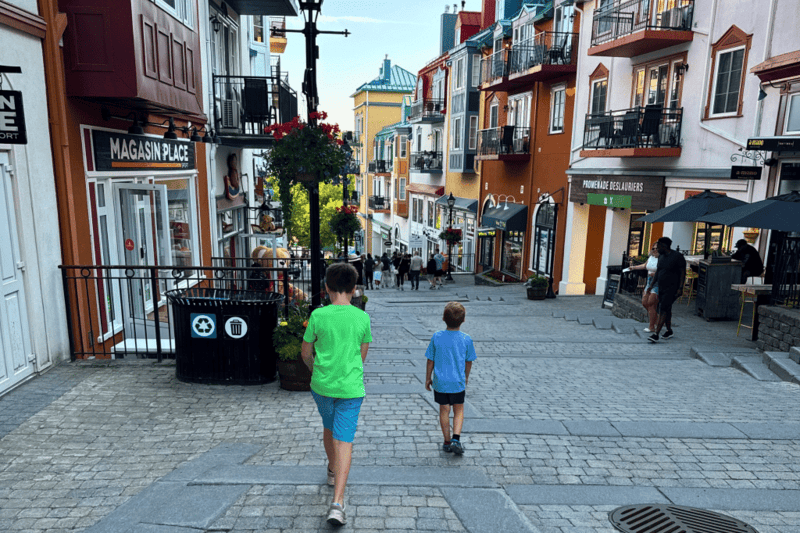 Two little boys walking down the cobble stones streets of Mont Tremblant