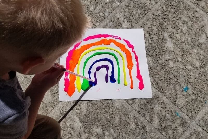 blow painting a rainbow using a straw