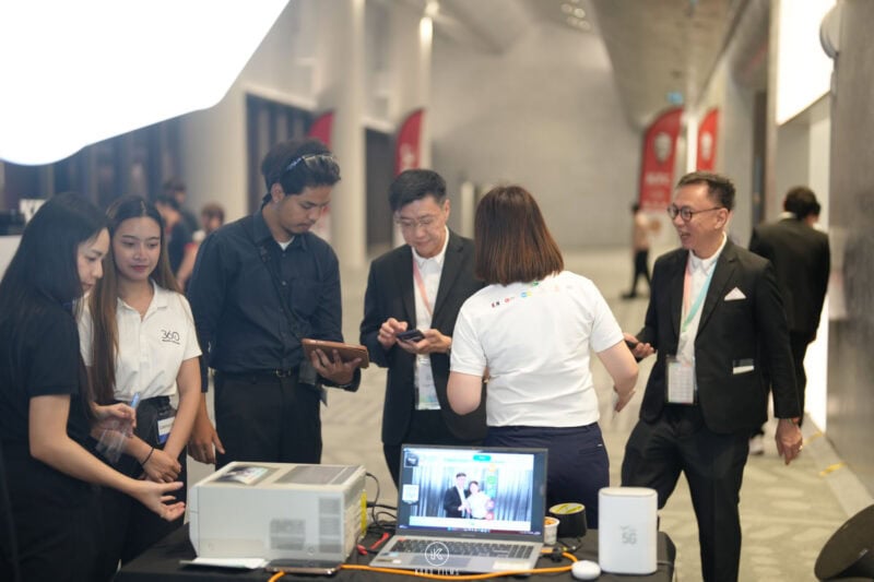 Instant photo printing station at a corporate event, with staff printing guests' photos on site