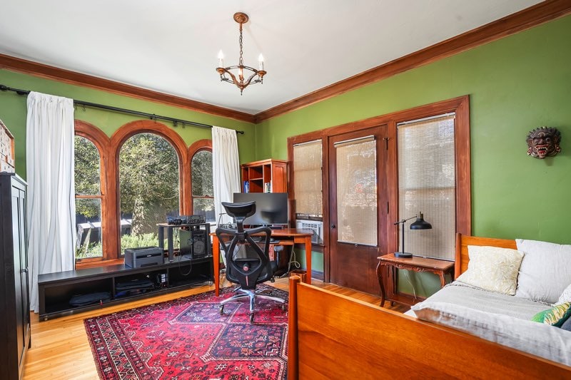 Versatile front office at showcasing triple arched windows, crown molding, and hardwood floors; an ideal studio or guest space with a private exterior entrance in North Park.