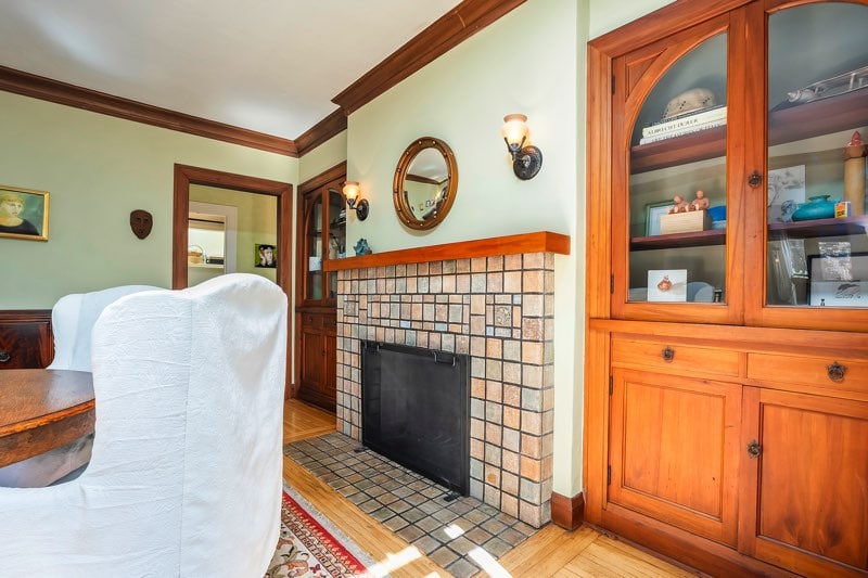 Detailed view of the Batchelder tile fireplace at 3237-39 Dale St, a classic architectural feature of this North Park Spanish-style home.
