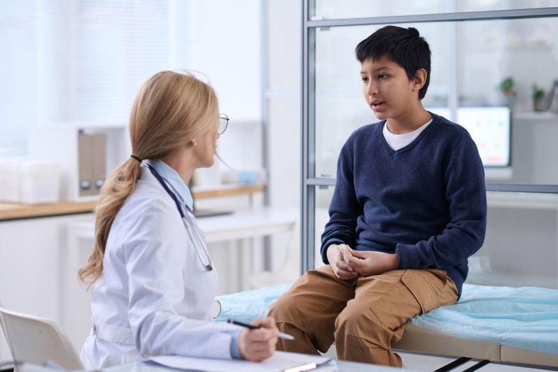 Boy Talking to Doctor in Clinic Boy Talking to Doctor in Clinic