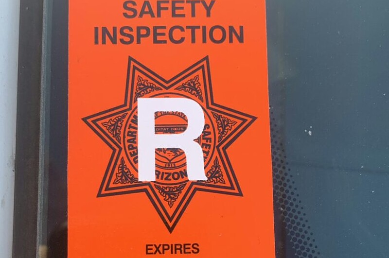 Arizona DPS tow truck inspection orange sticker displayed on Freeway Towing & Storage truck in Phoenix, proving DPS certified towing compliance