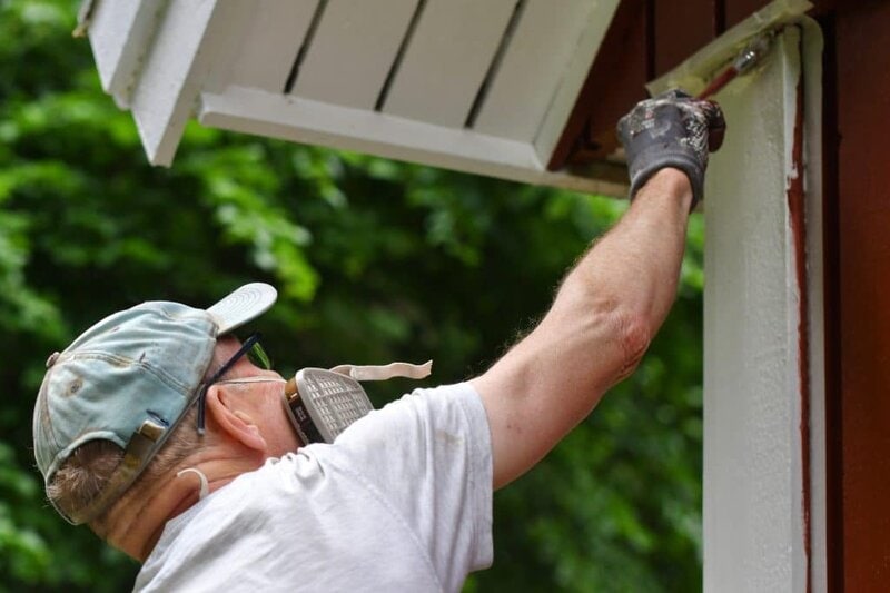 Expert Interior and Exterior Painting | King & Pierce Counties A man painting house exterior with white color