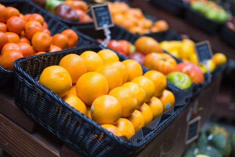 Fresh oranges in a market basket for healthy eating and vitamin C.