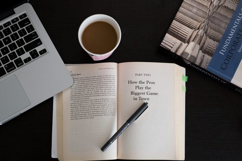 Modern workspace with laptop, open book, and coffee for business or study.