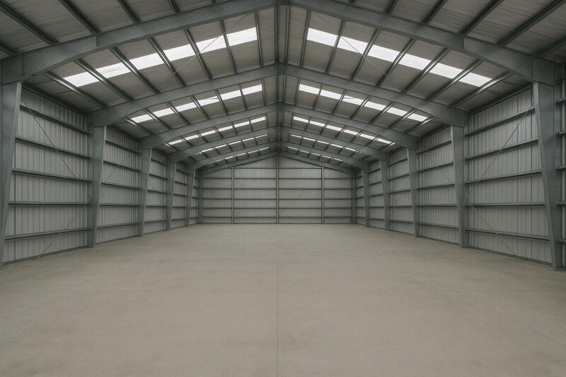 Interior view of a clear-span steel building showing rigid frames, purlins and girts