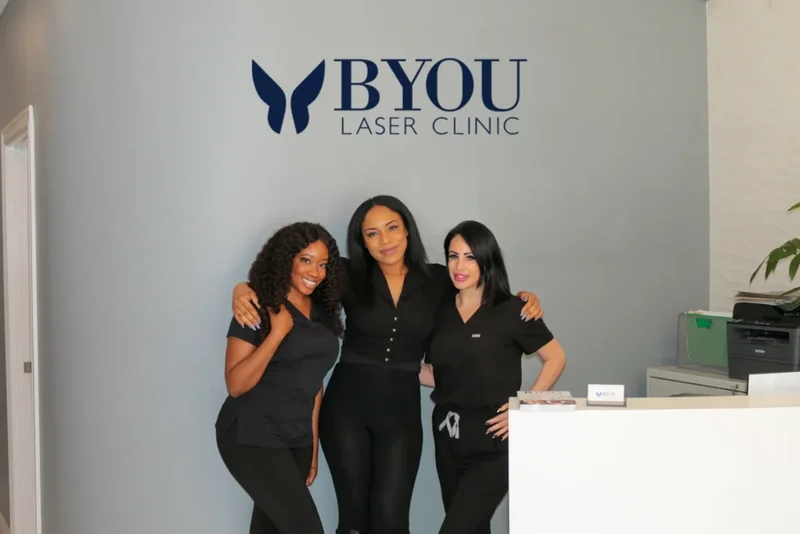 Workers standing together infront of BYou sign