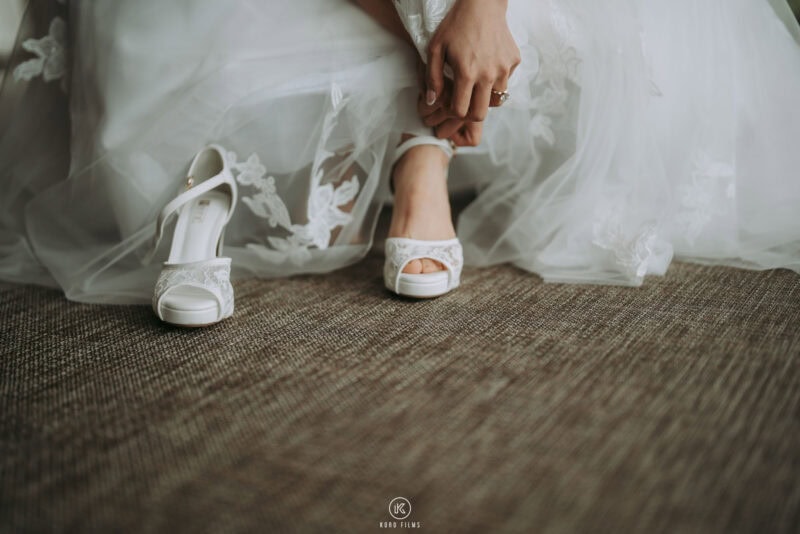 The bride slips on her white heels before the ceremony at The Ritz-Carlton, Koh Samui